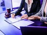 People at a lawyer's office signing a contract